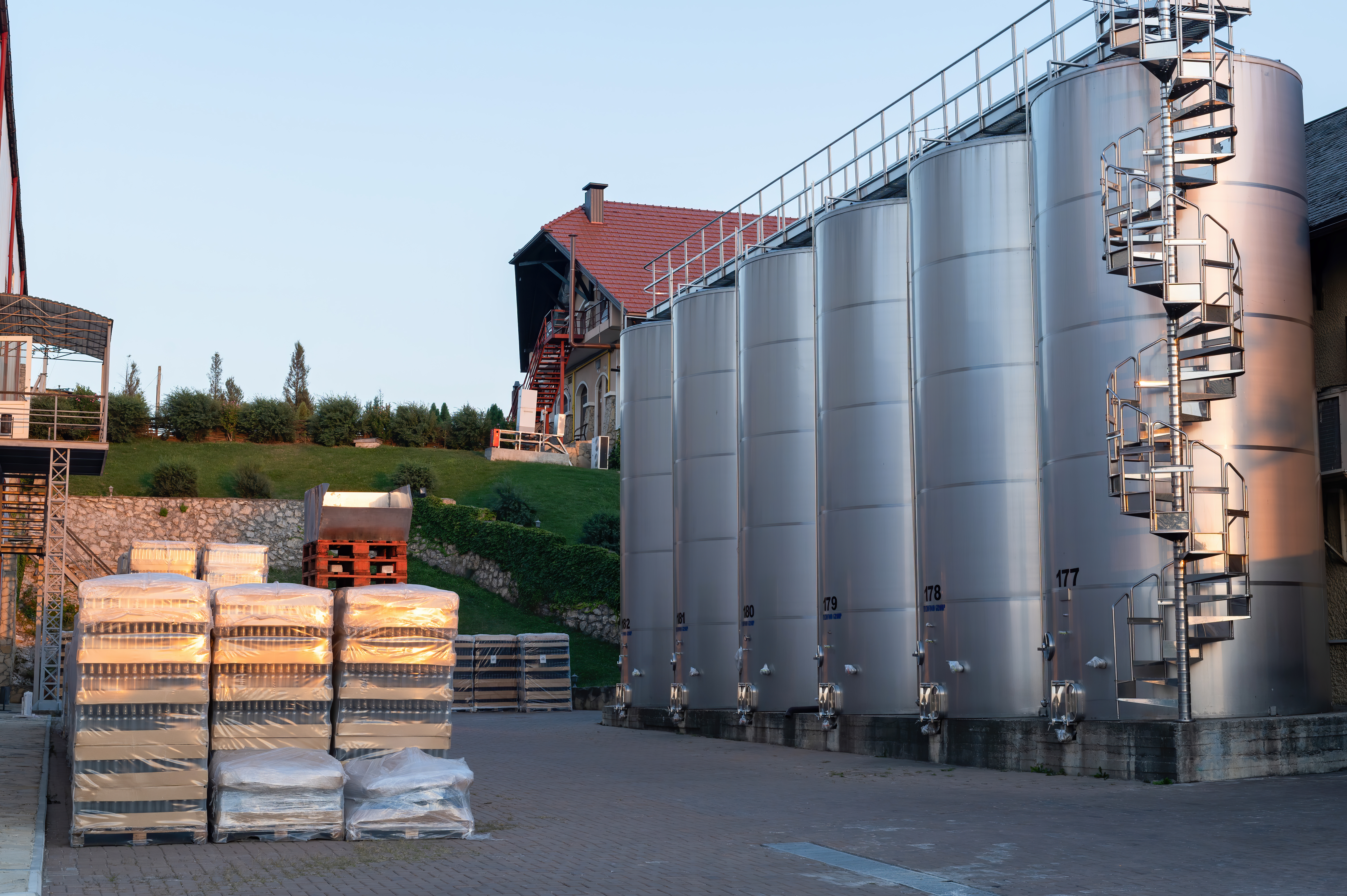 Industrial storage tanks at sunset
